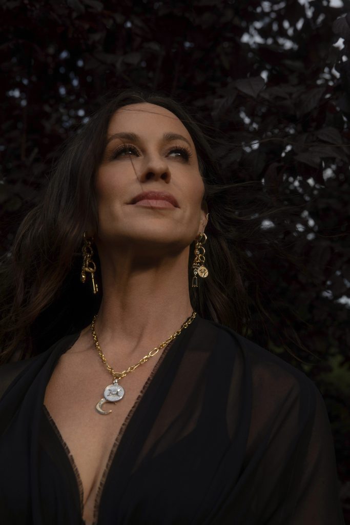 Alanis at her home in California wearing pieces from her Awe Inspired jewelry collection.