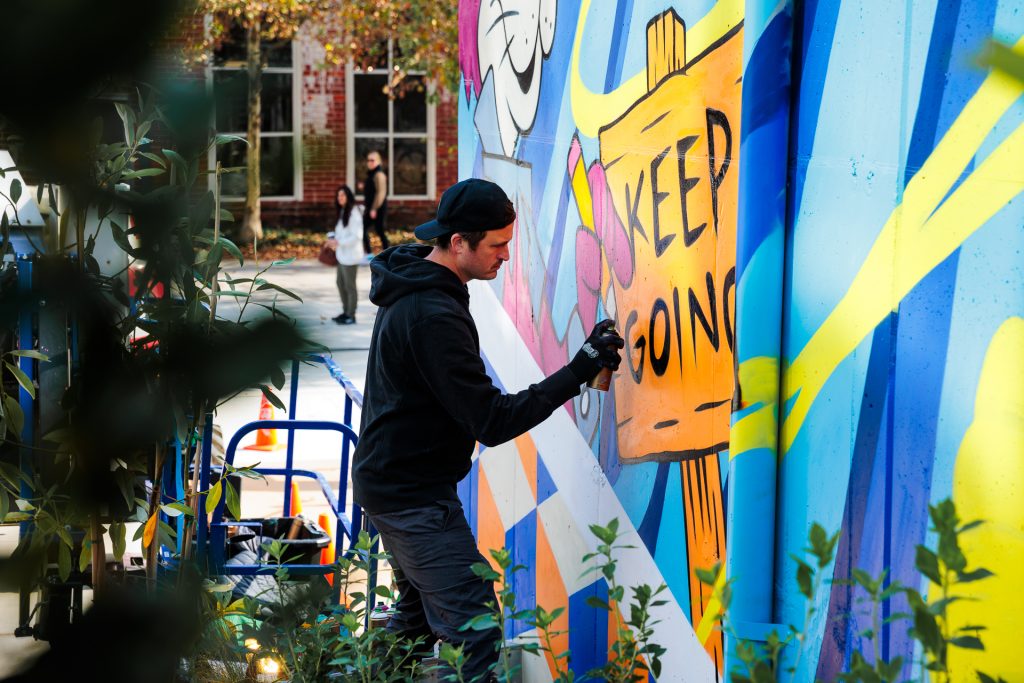 Visual Artist and Designer Greg Mike, working on the Atlanta Beltline mural.
Photo by Dave Roland