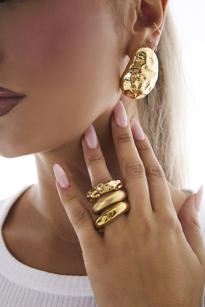 The Evanna Earrings and Ealiah Stacked Rings in Gold.